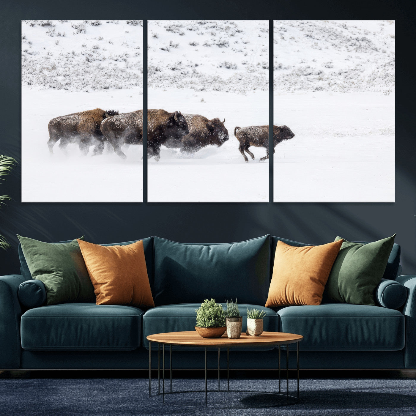 Bison herd running through a snowy open field with mountain backdrop, perfect for rustic or western-themed wall decoration.