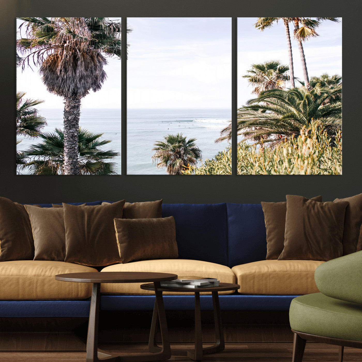 Scenic coastal view with tall palm trees overlooking a calm ocean, soft blue waves, and surfers in the distance, creating a peaceful tropical vibe.