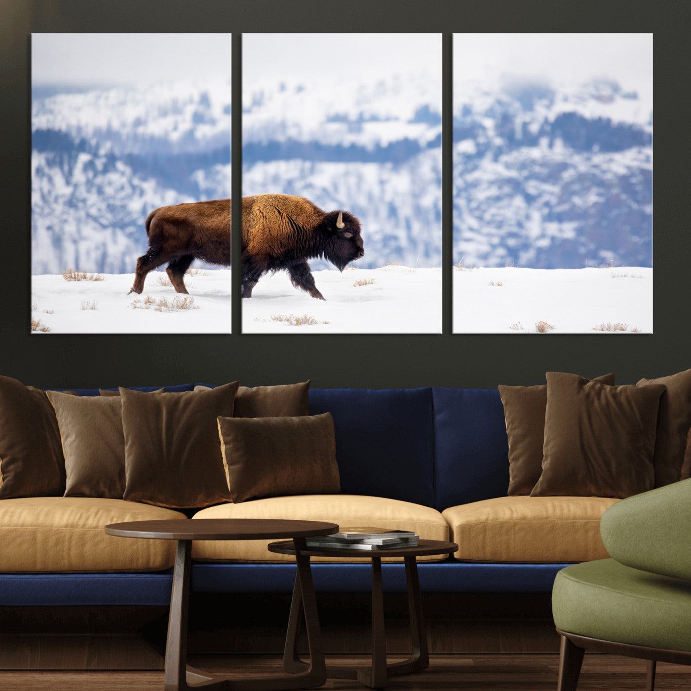A lone bison walks across snowy ground with blue-toned mountain range behind, ideal for rustic or western farmhouse interiors.