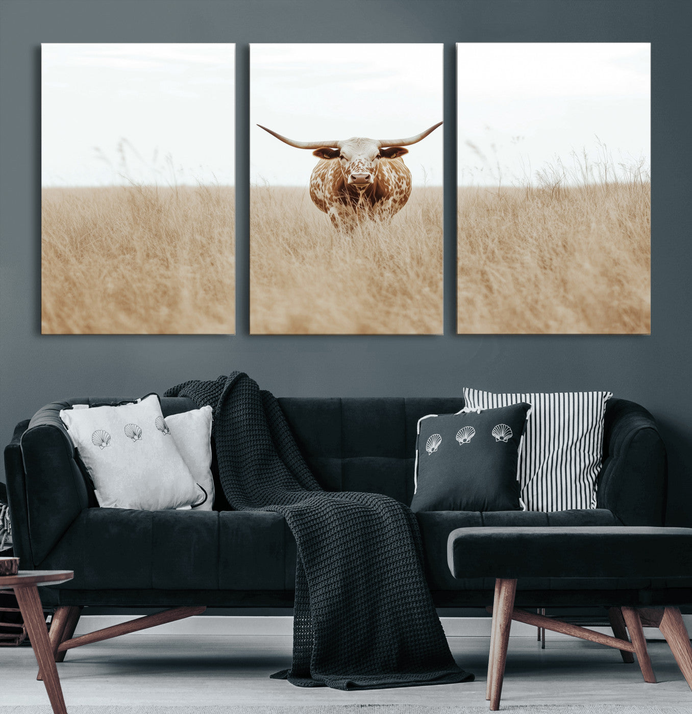 Texas Longhorn bull standing alone in dry grass with neutral tones, ideal for rustic western or cowboy-themed wall decor.