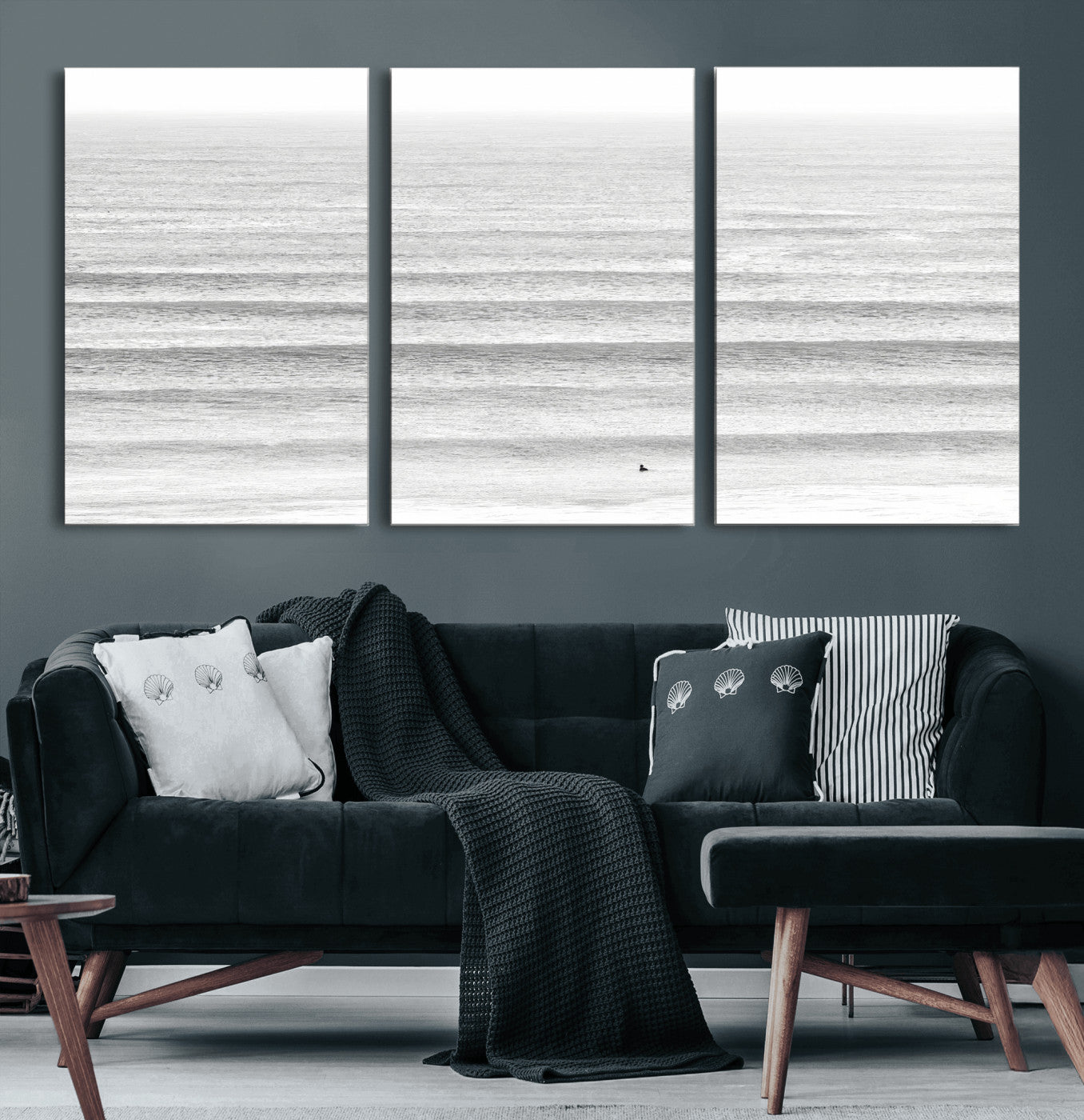 Monochrome photo of a lone surfer in calm layered waves, perfect for minimalist coastal or moody ocean-inspired wall decoration.