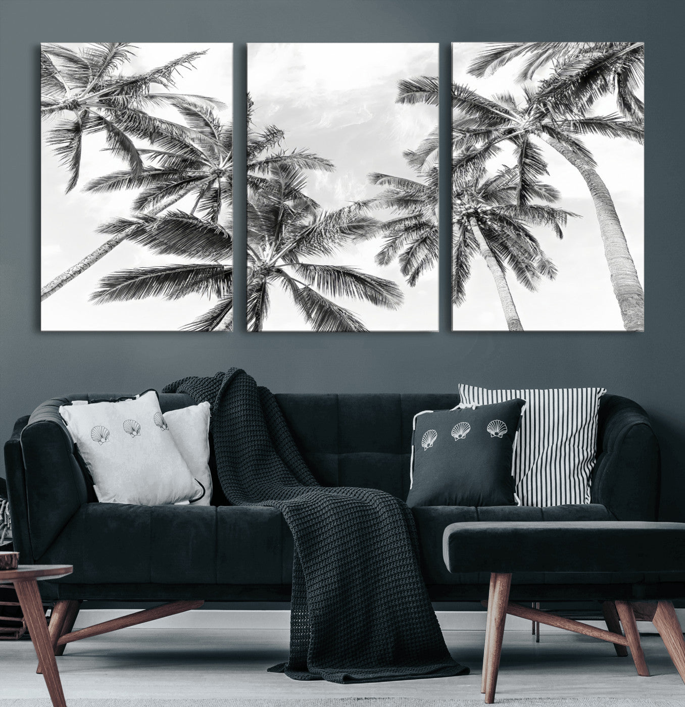 Black and white tropical palm trees viewed from below, swaying gently against a bright sky, creating a serene and elegant coastal atmosphere.