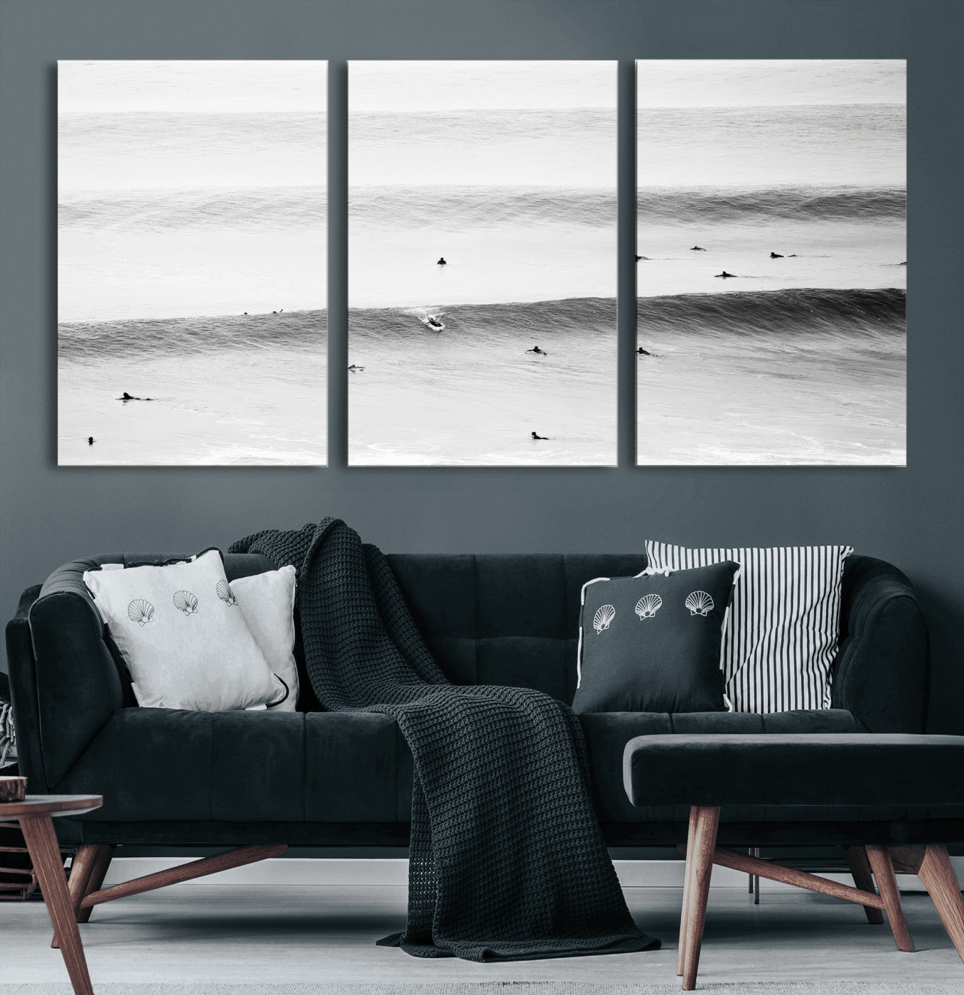 A monochrome photograph of swimmers gliding through gentle ocean waves, evoking a sense of calm and movement.