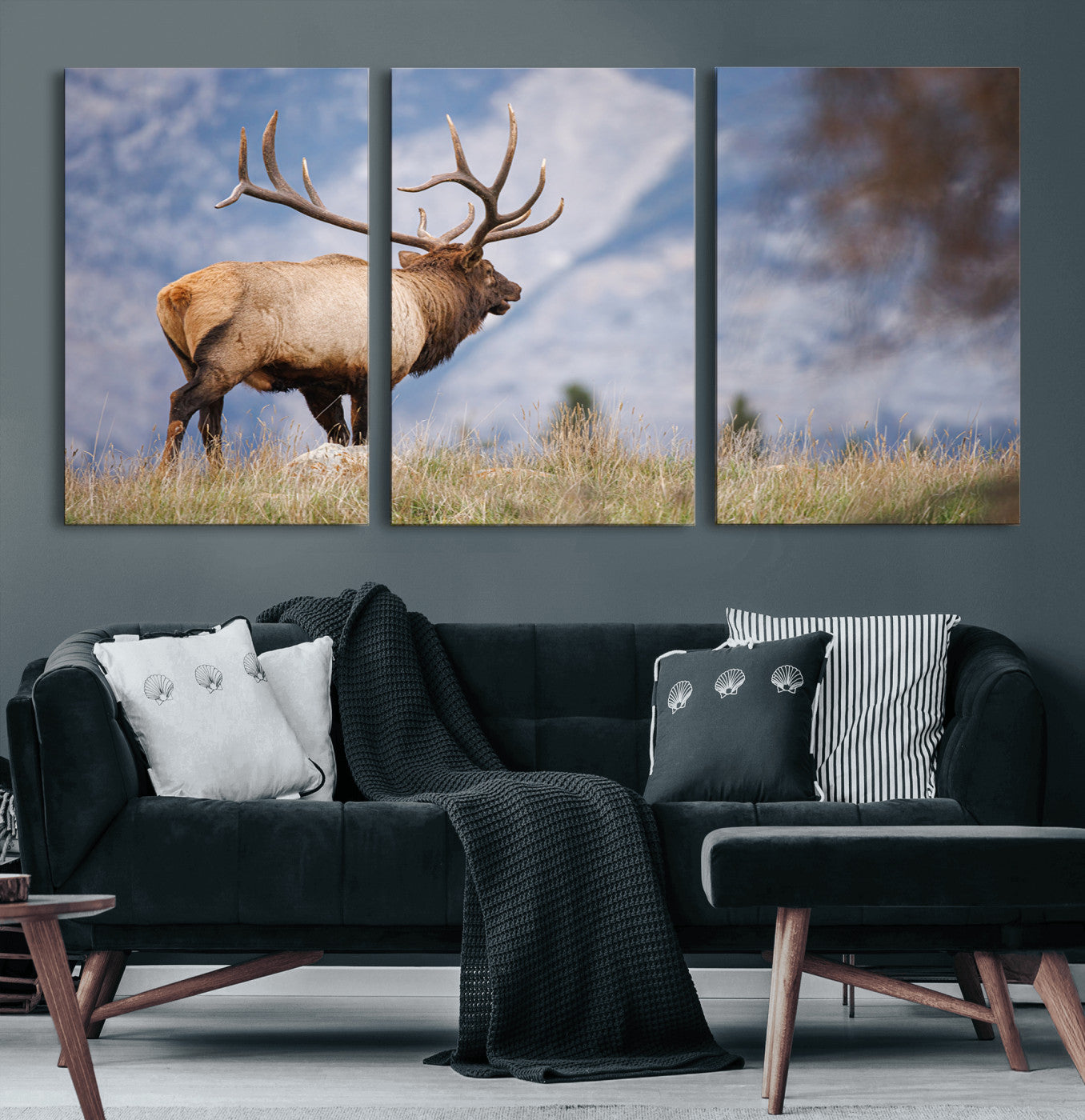 Elk with antlers standing on grass with mountain background, ideal for rustic, cabin, or lodge-inspired wall decor.