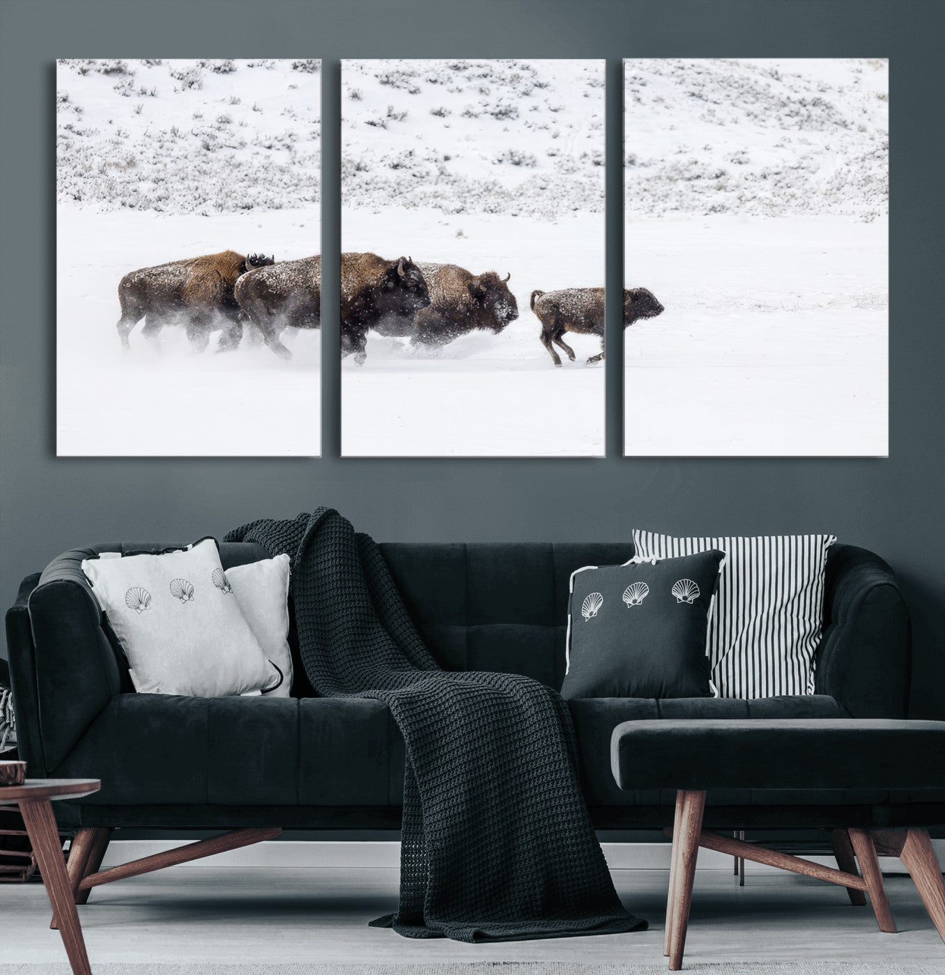 Bison herd running through a snowy open field with mountain backdrop, perfect for rustic or western-themed wall decoration.