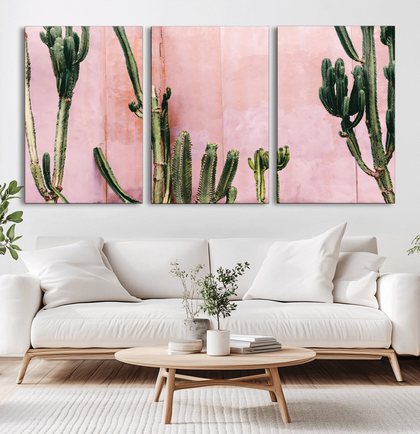 Framed canvas of tall green cacti against a soft pink wall, ideal for modern desert or colorful southwest-inspired home decor.