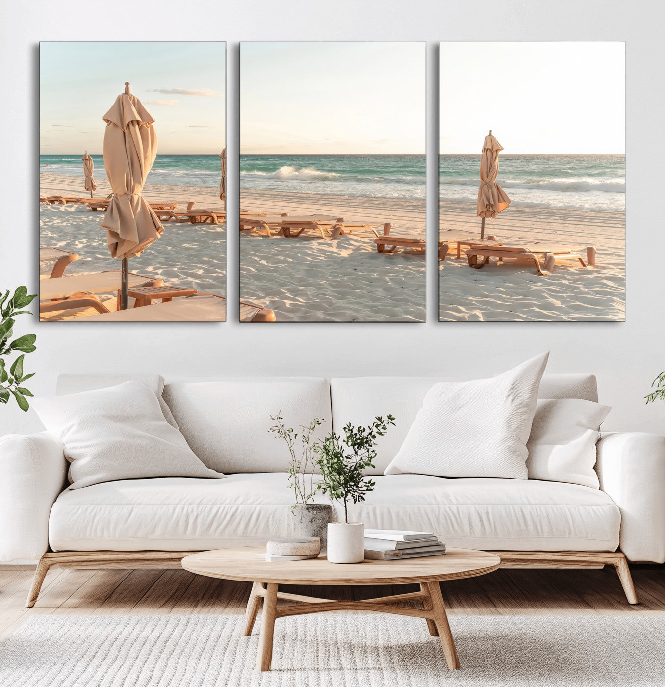 Minimalist photo of empty beach loungers and umbrellas on soft sand, ideal for calm seaside or pastel coastal-style home decor.