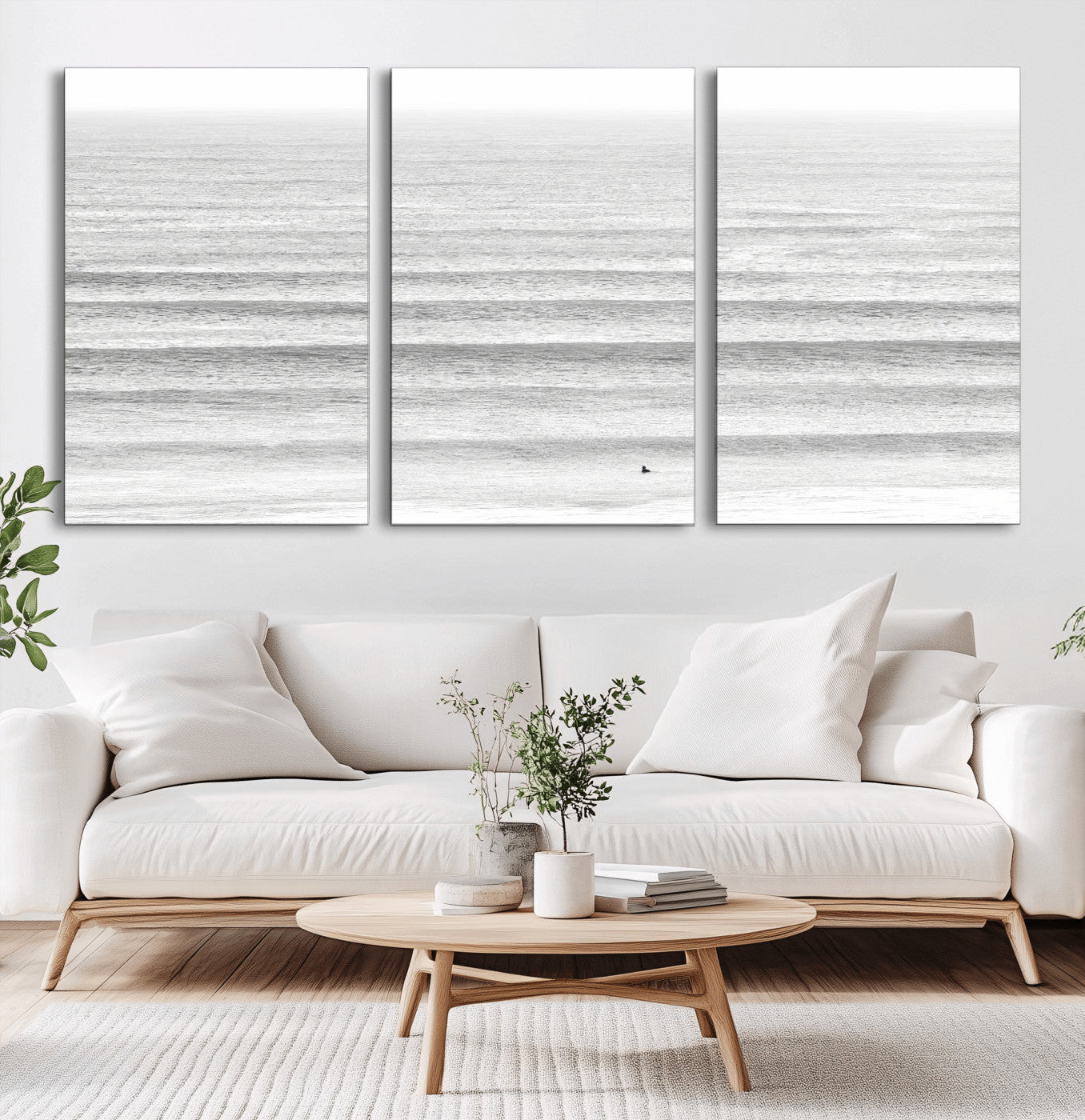 Monochrome photo of a lone surfer in calm layered waves, perfect for minimalist coastal or moody ocean-inspired wall decoration.