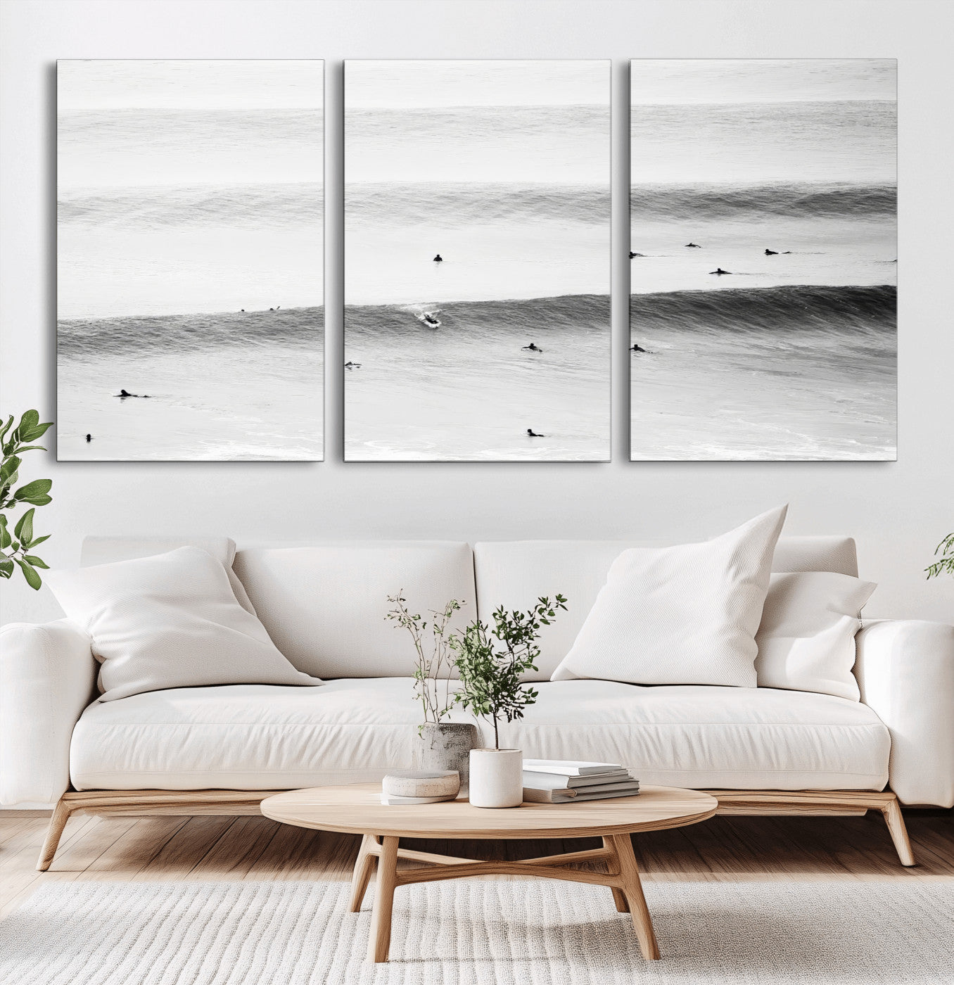 A monochrome photograph of swimmers gliding through gentle ocean waves, evoking a sense of calm and movement.