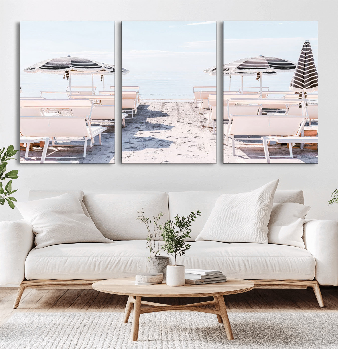 A serene minimalist beach scene featuring striped umbrellas, soft pastel sand, and an elegant lounge setup, creating a tranquil and stylish coastal retreat.