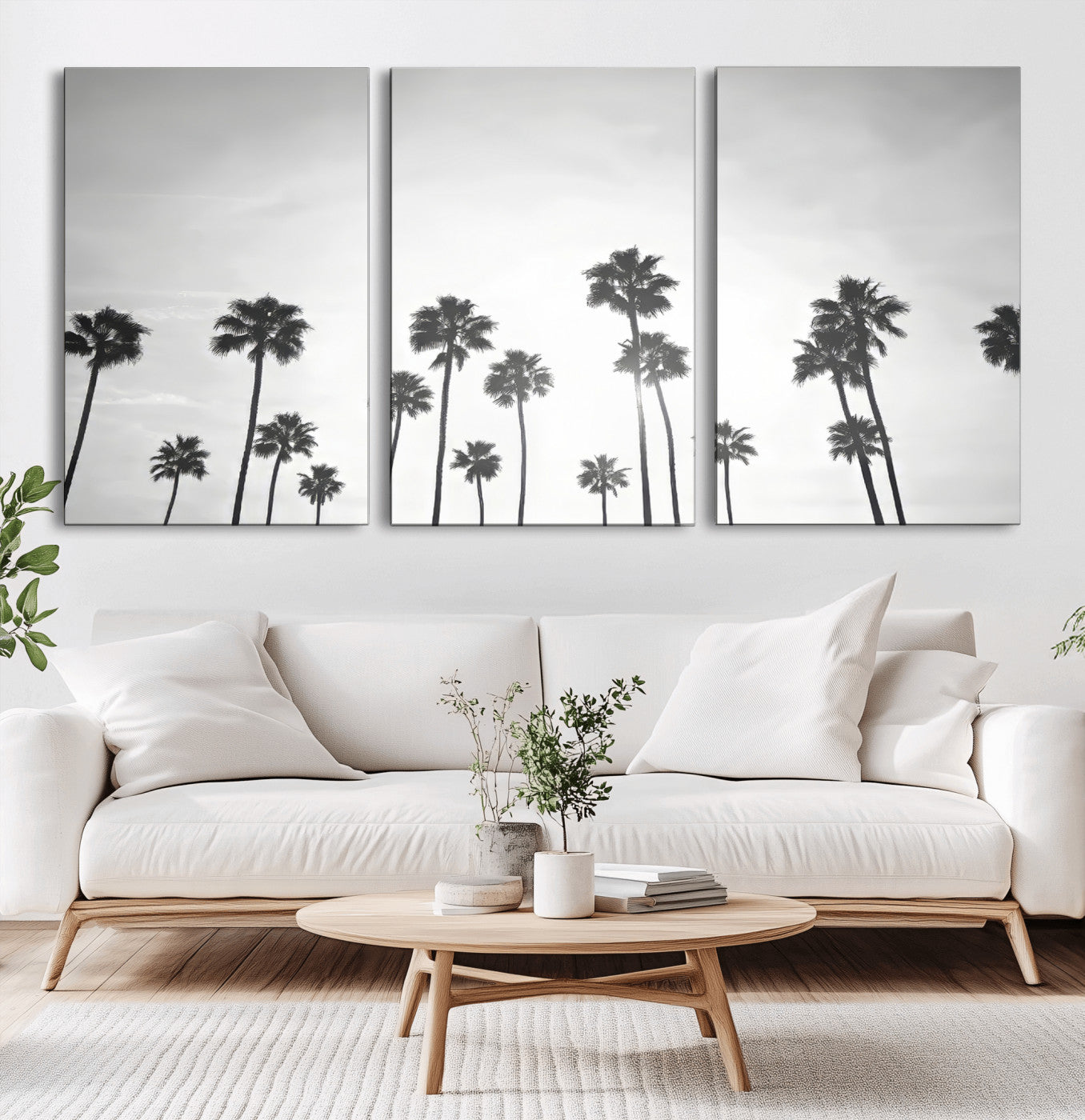 A black and white minimalist scene featuring tall palm trees silhouetted against a bright sky, creating a dreamy and timeless tropical aesthetic.
