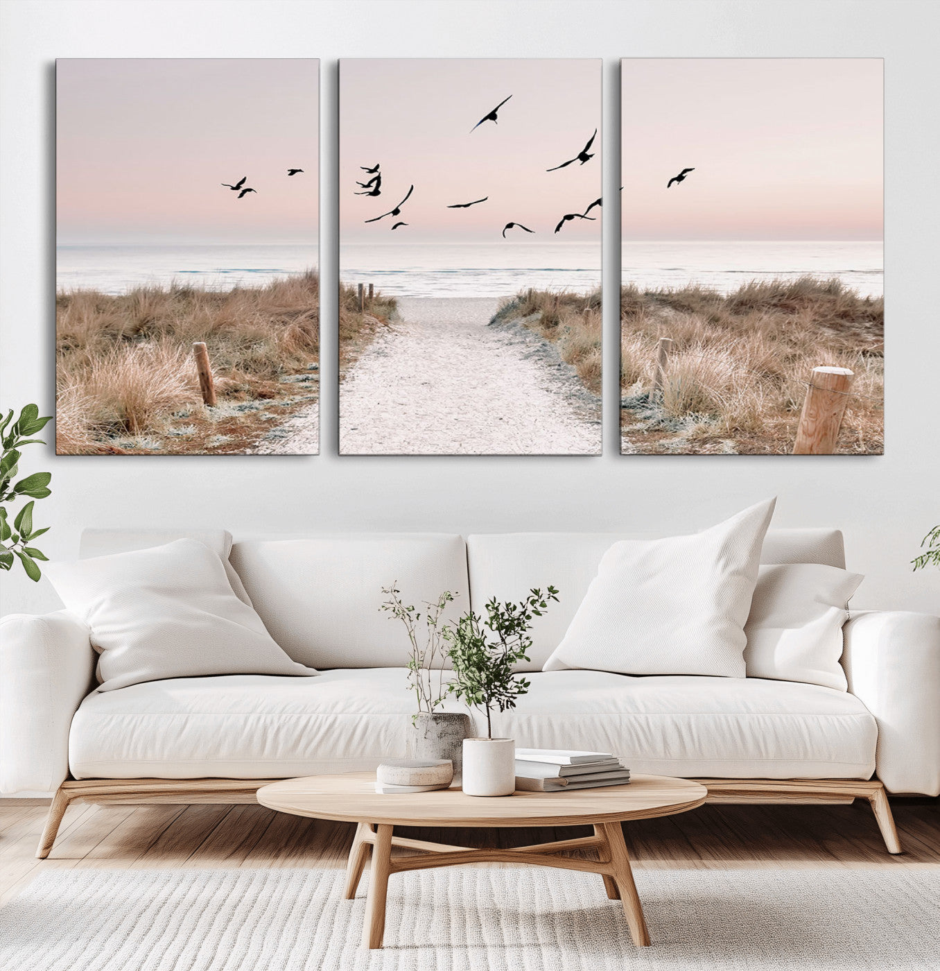 A peaceful coastal pathway leading to the ocean, with birds flying across a soft pastel sky, creating a calm and scenic beach atmosphere.