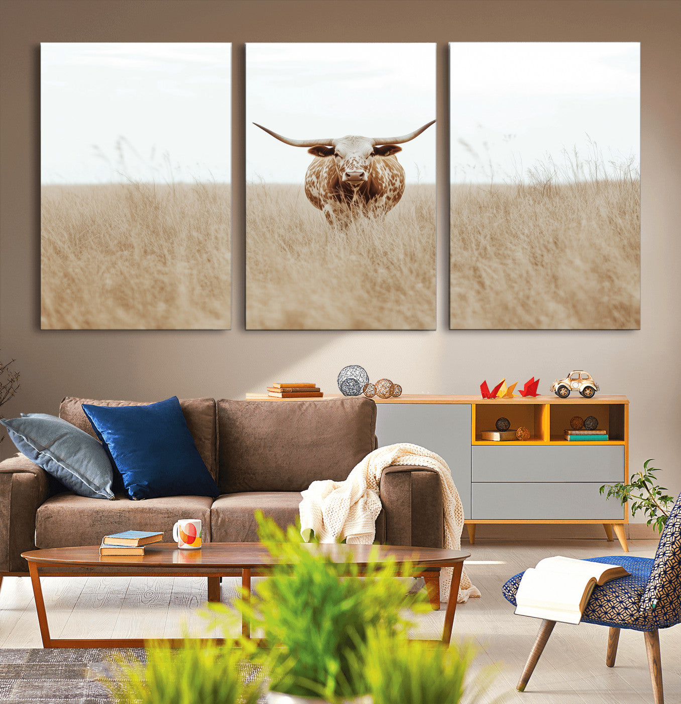 Texas Longhorn bull standing alone in dry grass with neutral tones, ideal for rustic western or cowboy-themed wall decor.