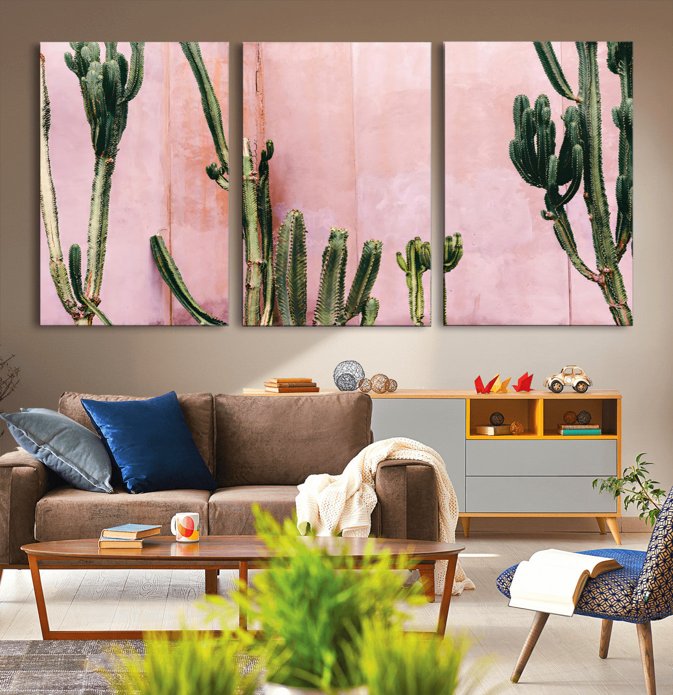 Framed canvas of tall green cacti against a soft pink wall, ideal for modern desert or colorful southwest-inspired home decor.