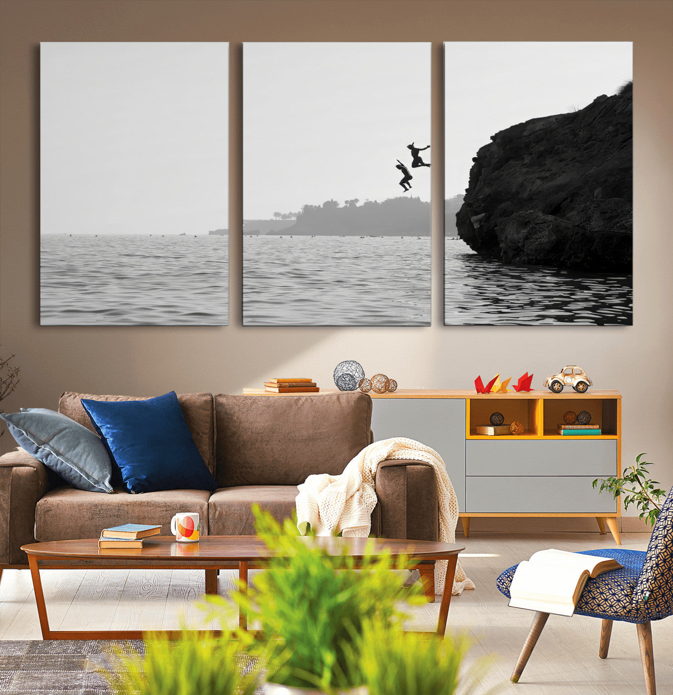 Black and white canvas of two figures cliff jumping into the sea, captured with moody tones, ideal for modern coastal or adventure-themed home decor. 2/2