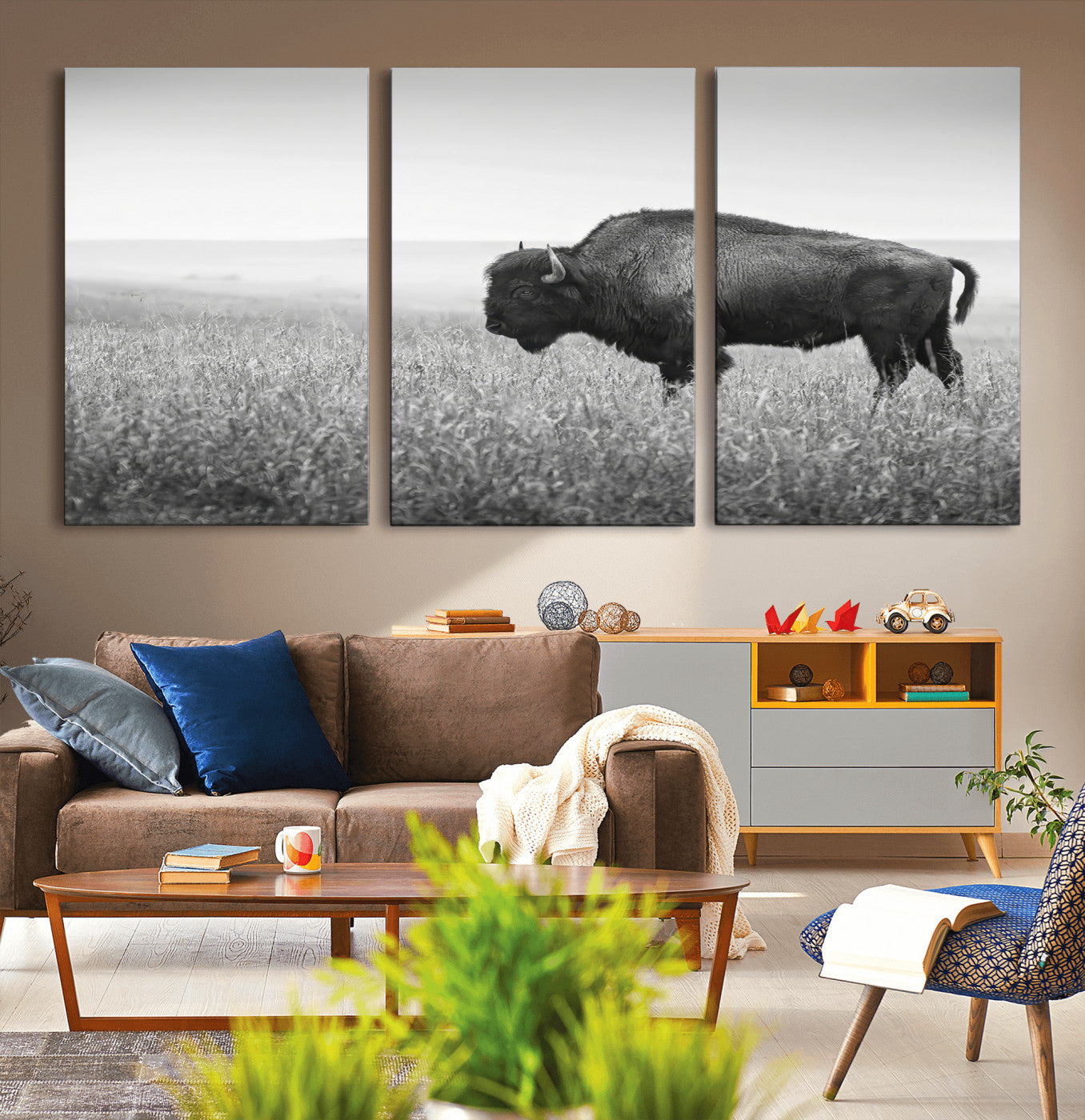 A black and white photograph of a majestic bison standing in a vast grassy prairie, evoking a sense of wilderness and strength.