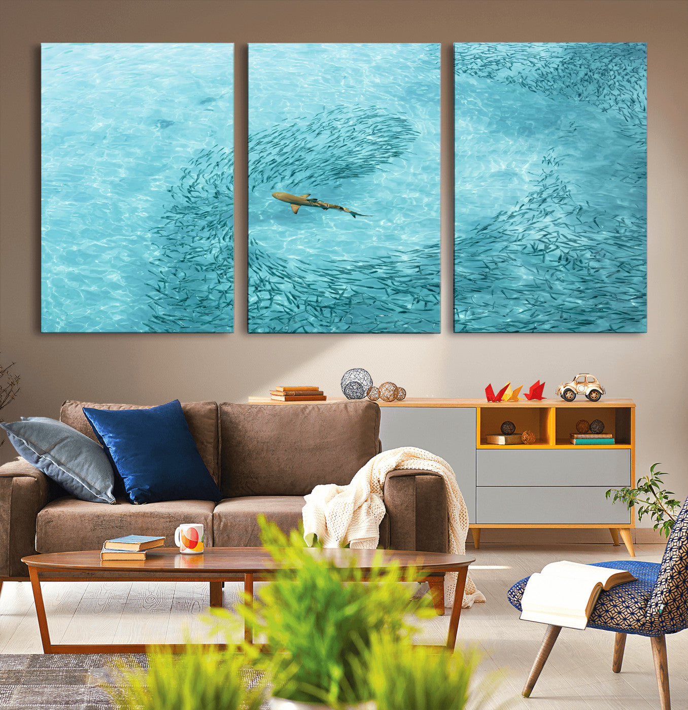 Aerial view of a shark swimming through a swirl of fish in clear turquoise waters, perfect for calm coastal or beach house decor.