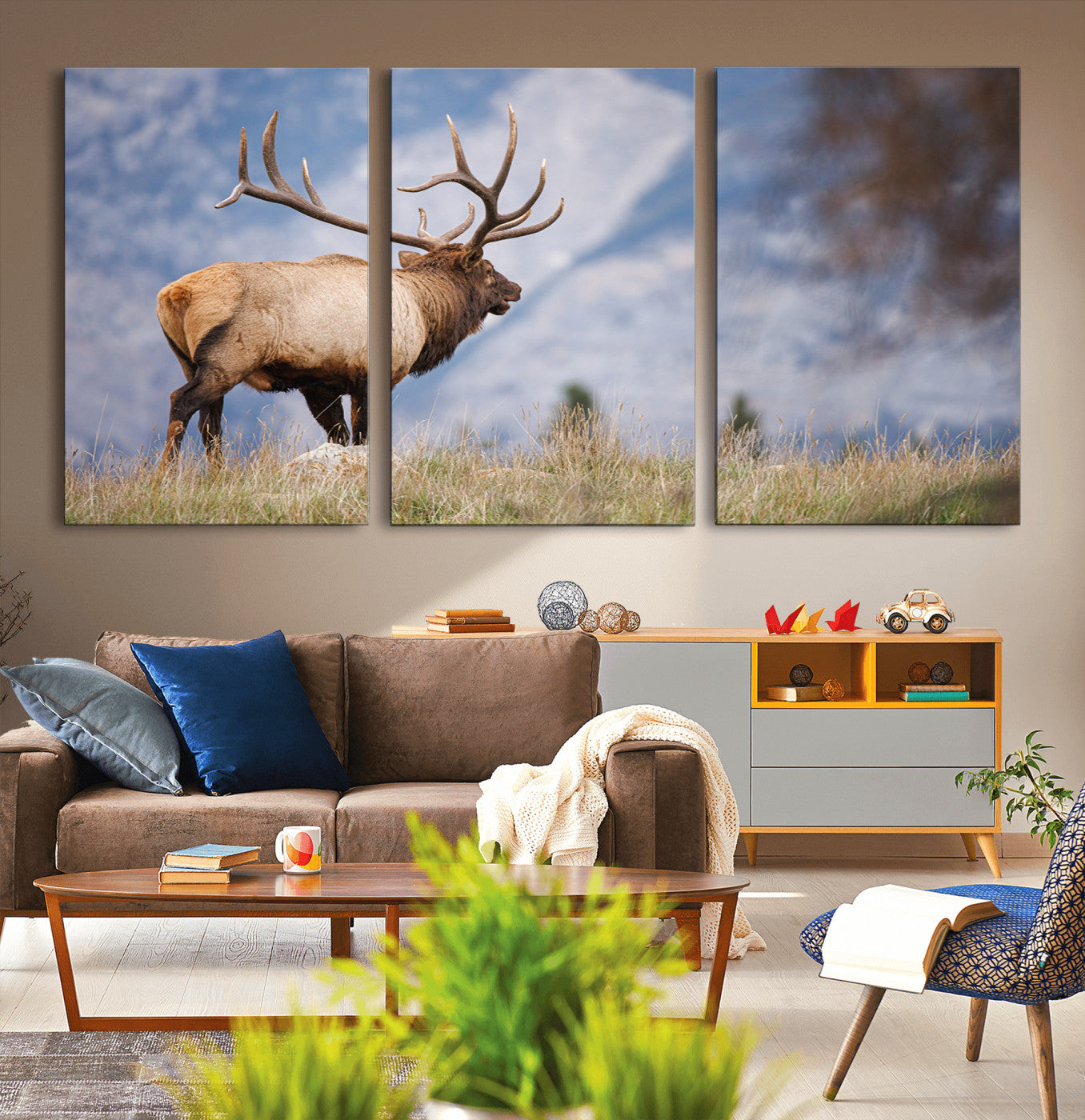 Elk with antlers standing on grass with mountain background, ideal for rustic, cabin, or lodge-inspired wall decor.