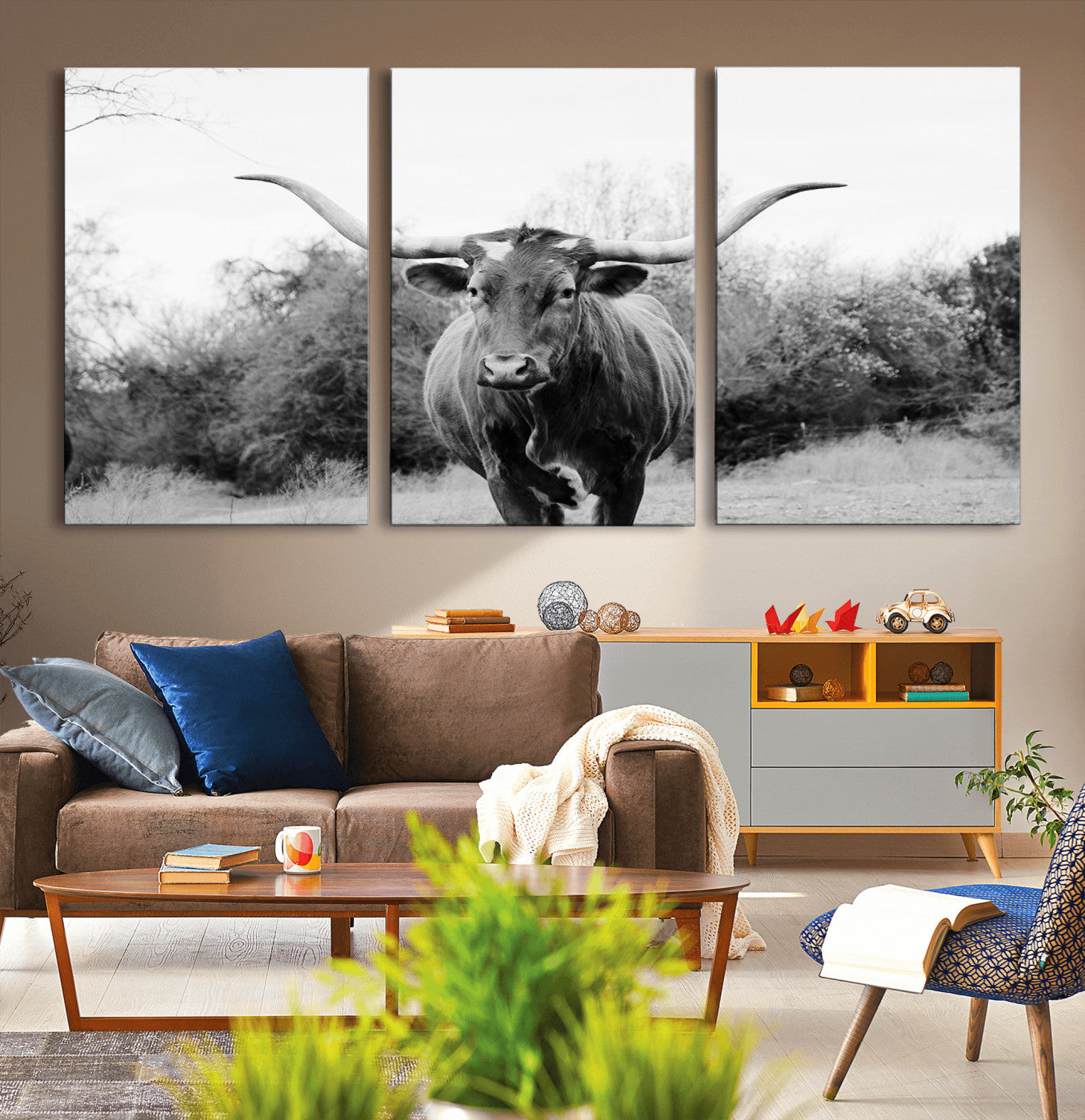 Black and white photo of a longhorn cow in a field, perfect for rustic farmhouse or western-themed interior wall decoration.