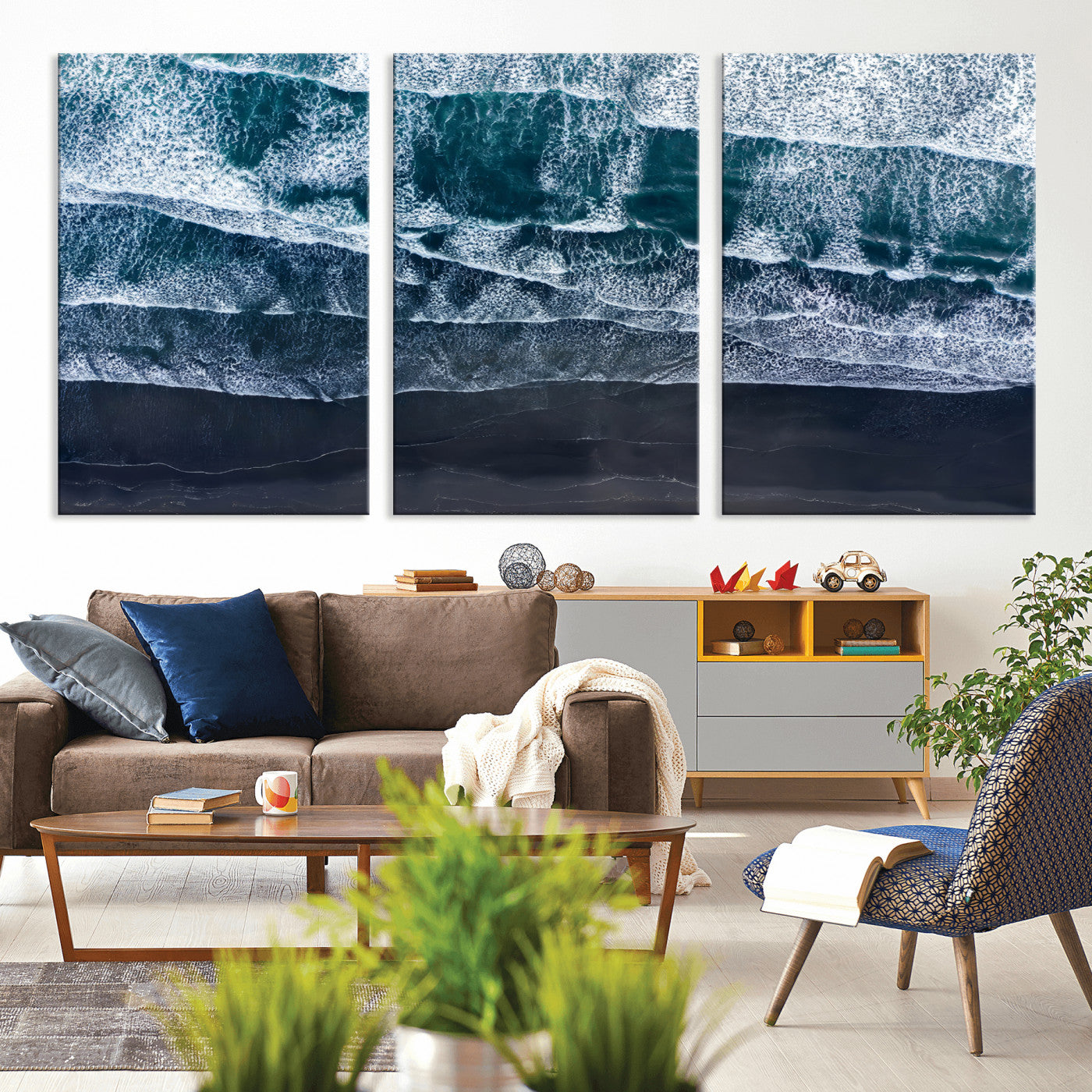 Canvas of aerial ocean waves crashing onto a black sand beach in moody tones, ideal for modern coastal or minimalist home decor.