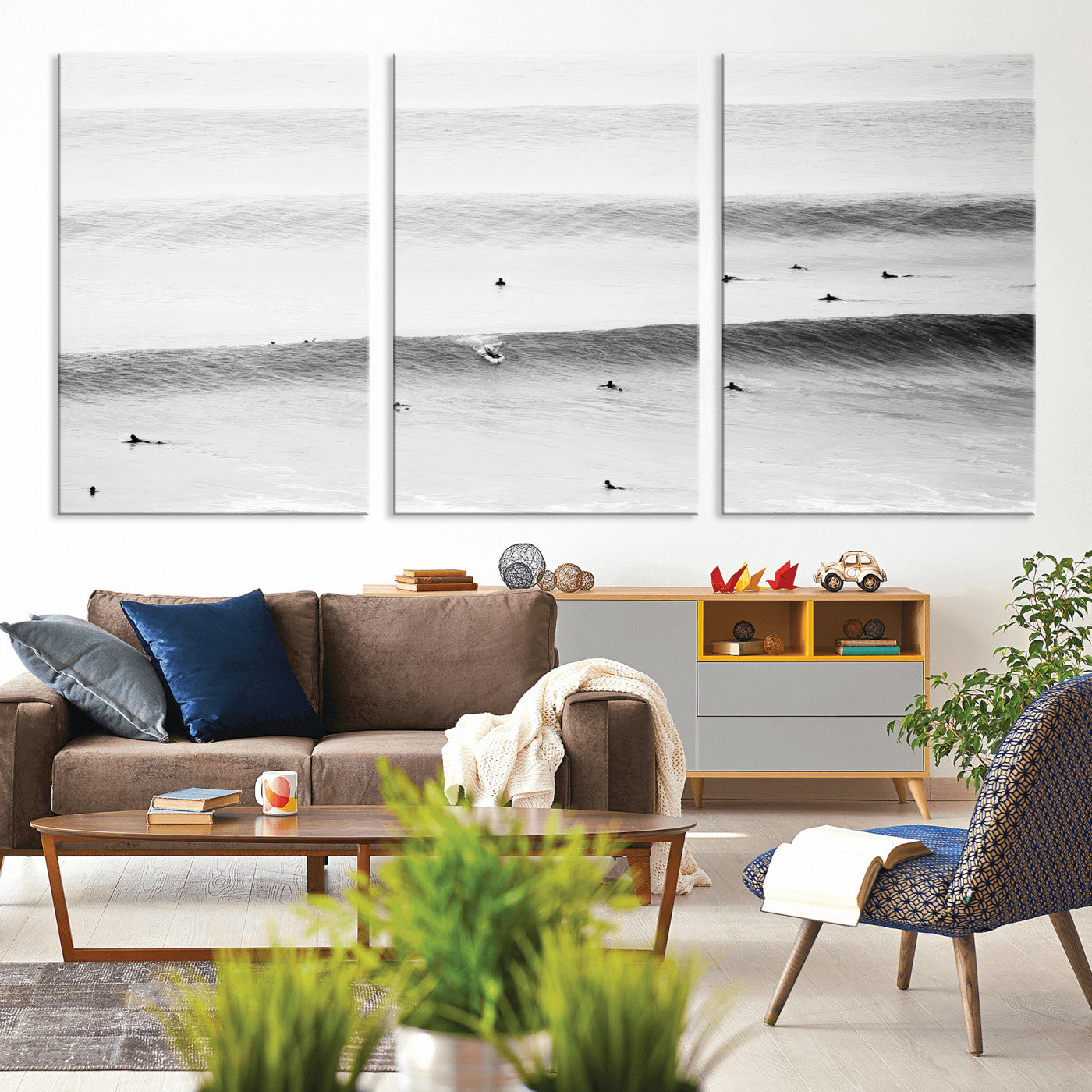 A monochrome photograph of swimmers gliding through gentle ocean waves, evoking a sense of calm and movement.