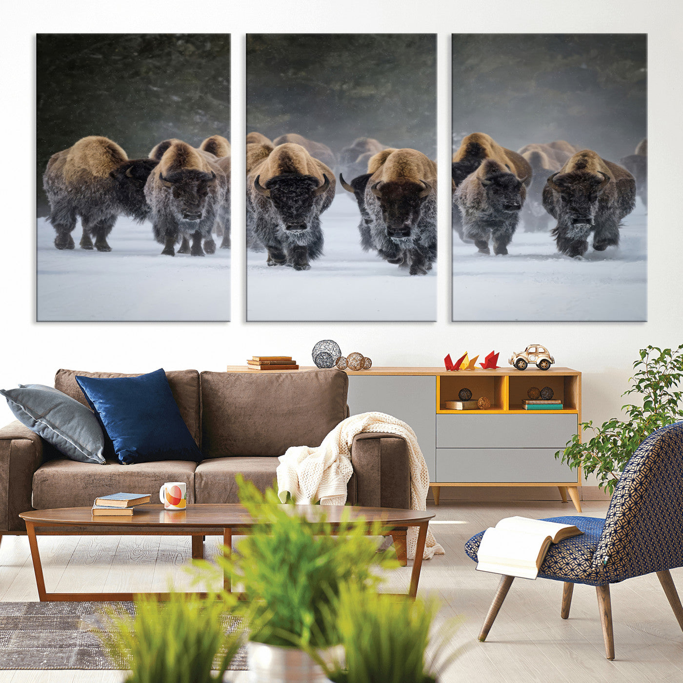 A herd of American bisons walking through deep snow in a forest, evoking a powerful rustic wilderness mood for western-style interiors.