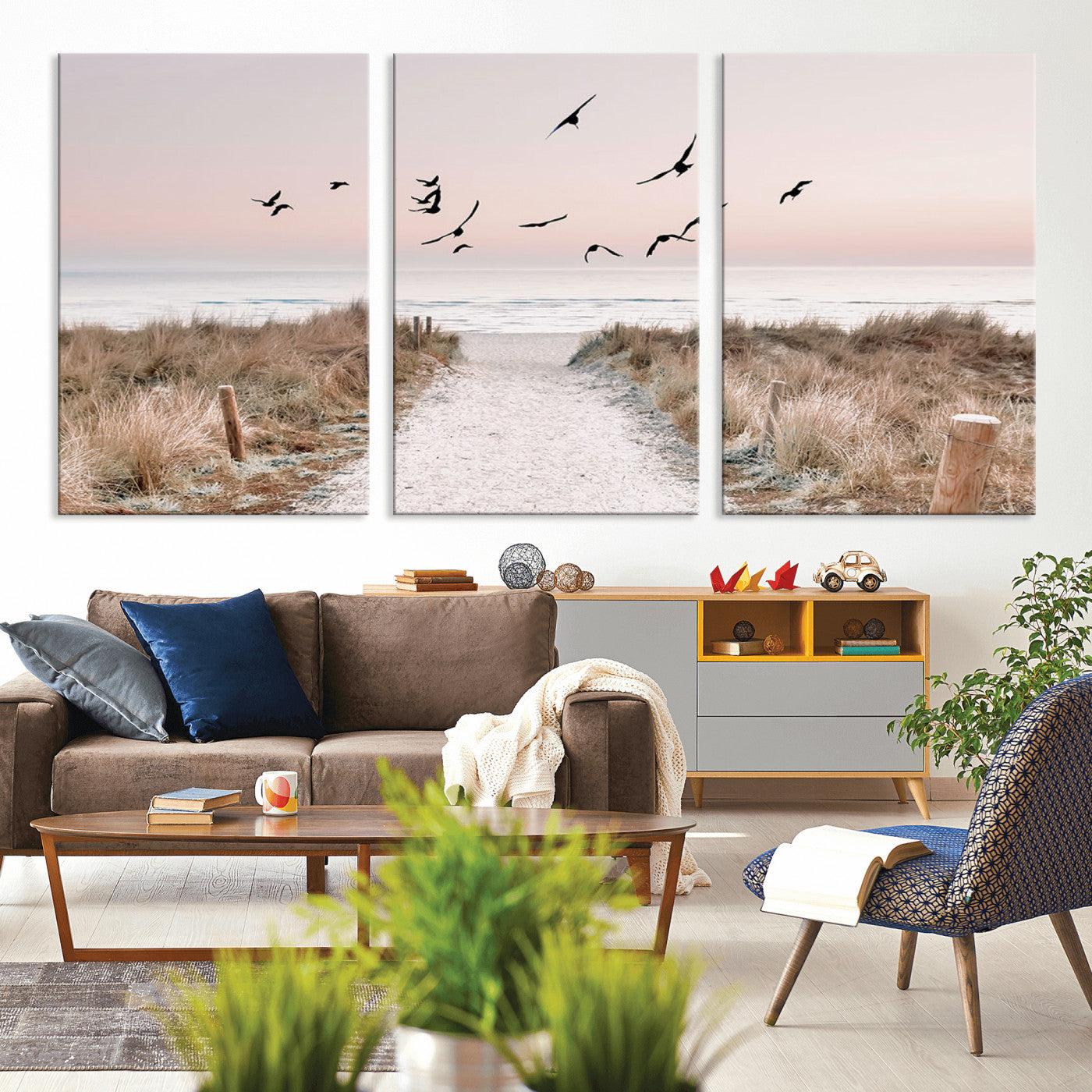 A peaceful coastal pathway leading to the ocean, with birds flying across a soft pastel sky, creating a calm and scenic beach atmosphere.