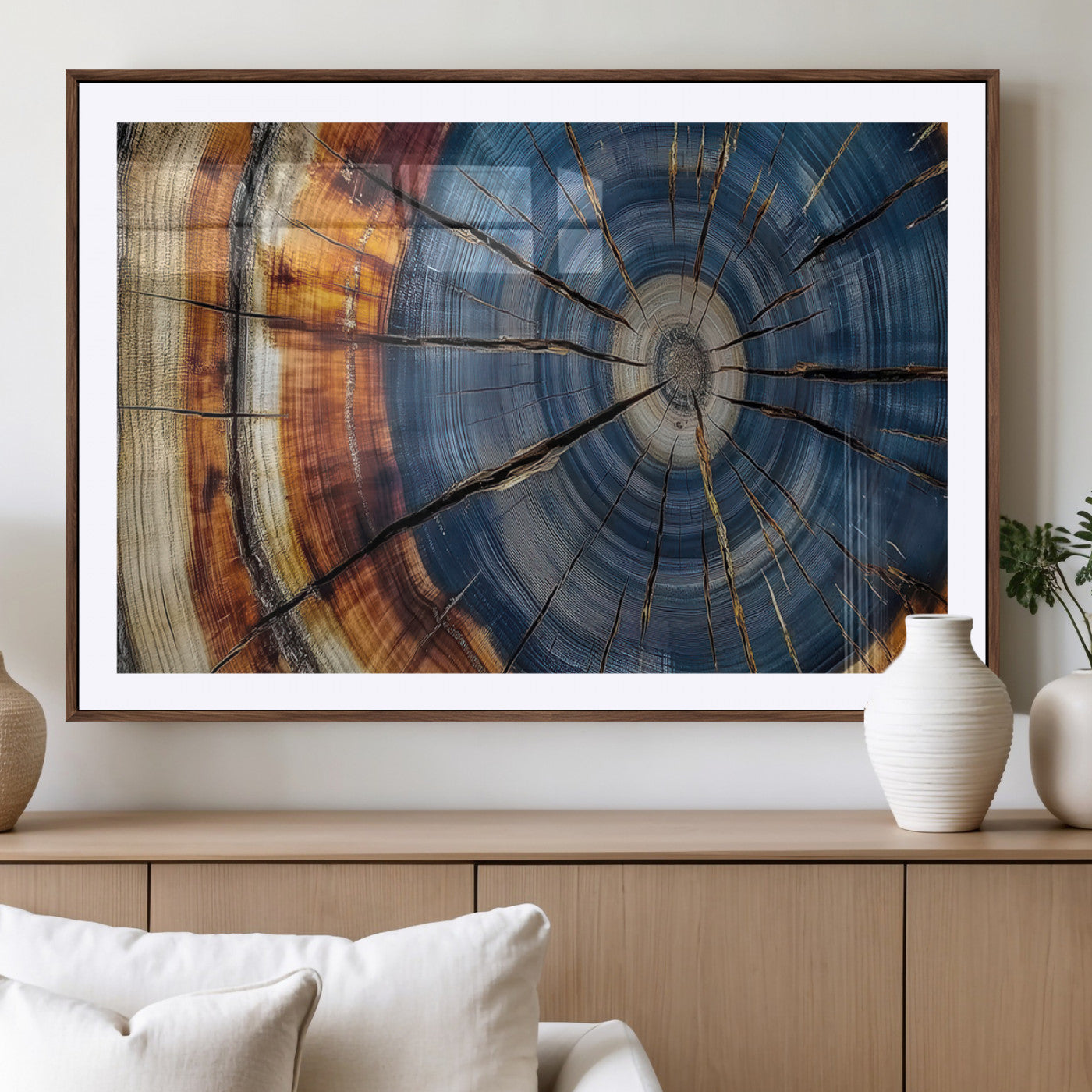 A stunning close-up view of a tree trunk, showcasing the intricate growth rings in a vibrant mix of warm browns, cool blues, and hints of natural texture.