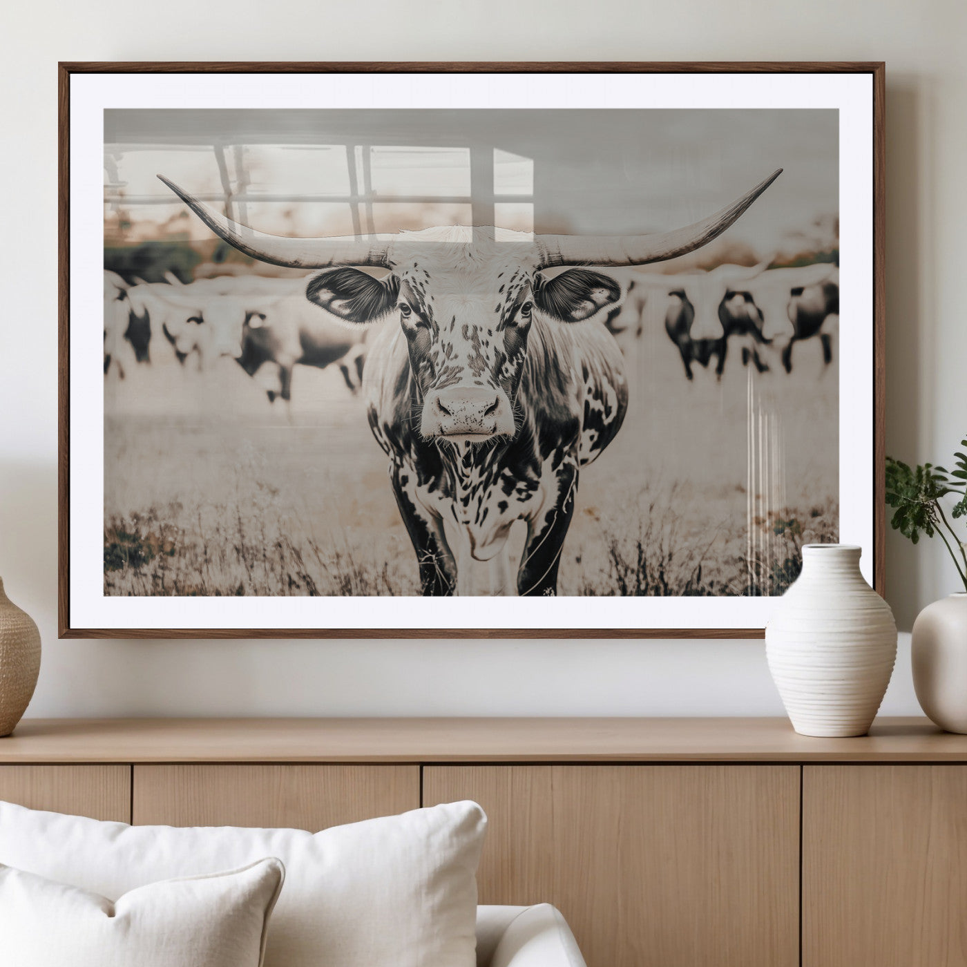 Canvas of a speckled Texas longhorn standing boldly in a field with a herd behind, perfect for rustic western or farmhouse wall decor.