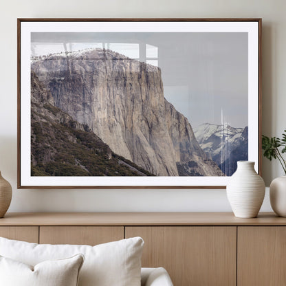 Framed canvas of El Capitan’s vertical granite face in Yosemite with snowy peaks, ideal for Sierra minimalism or mountain-inspired decor.