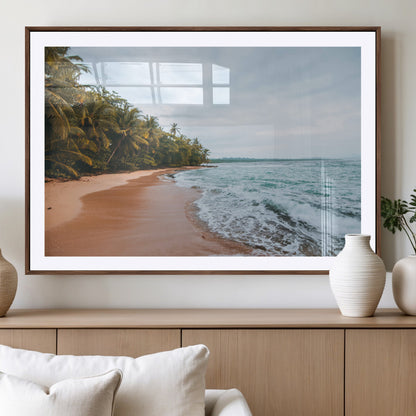 Framed canvas of a tropical beach with palm trees and soft waves, ideal for coastal escape or serene nature-inspired home decor.