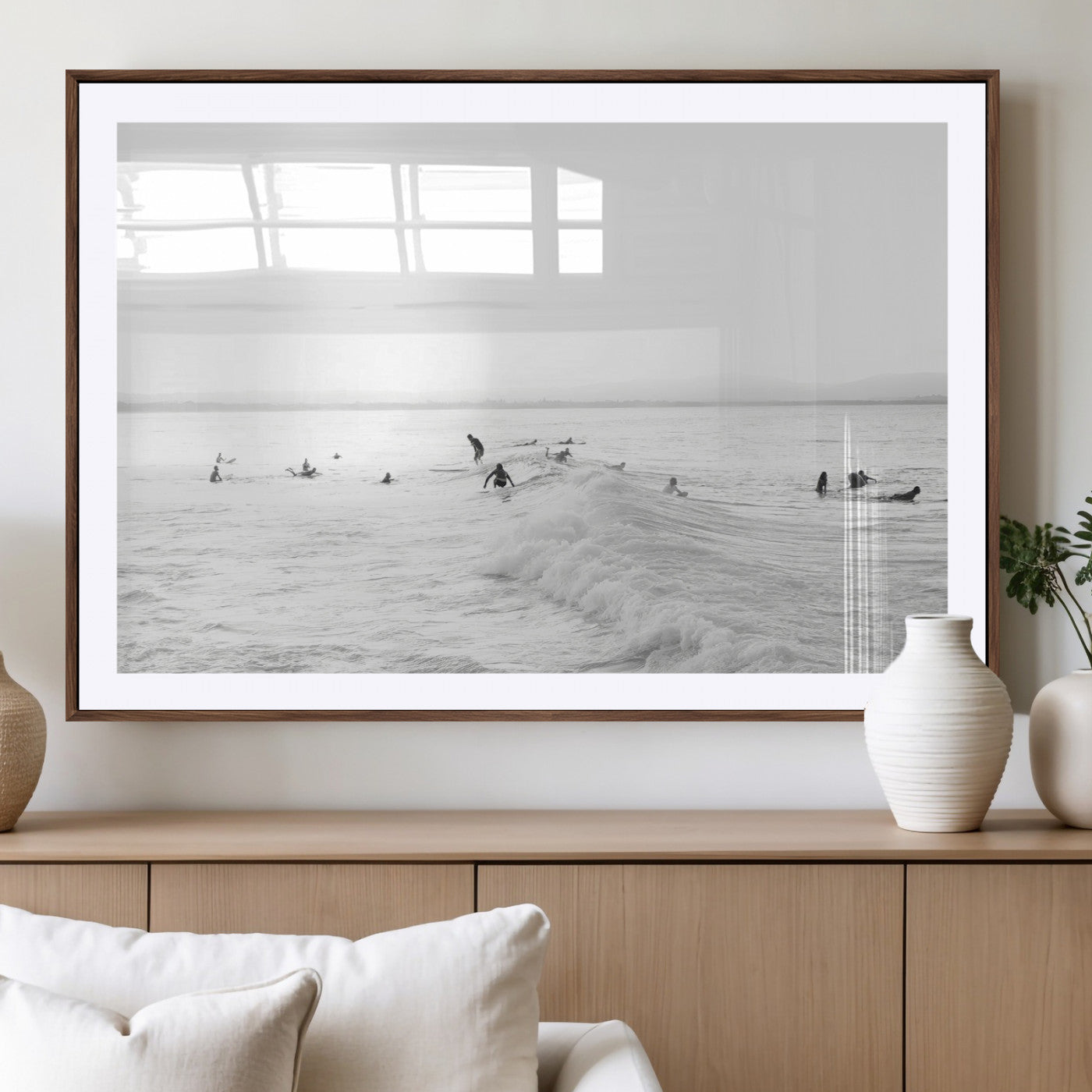Monochrome photo of surfers riding and waiting on ocean waves, ideal for surf-themed or coastal energy wall decor.