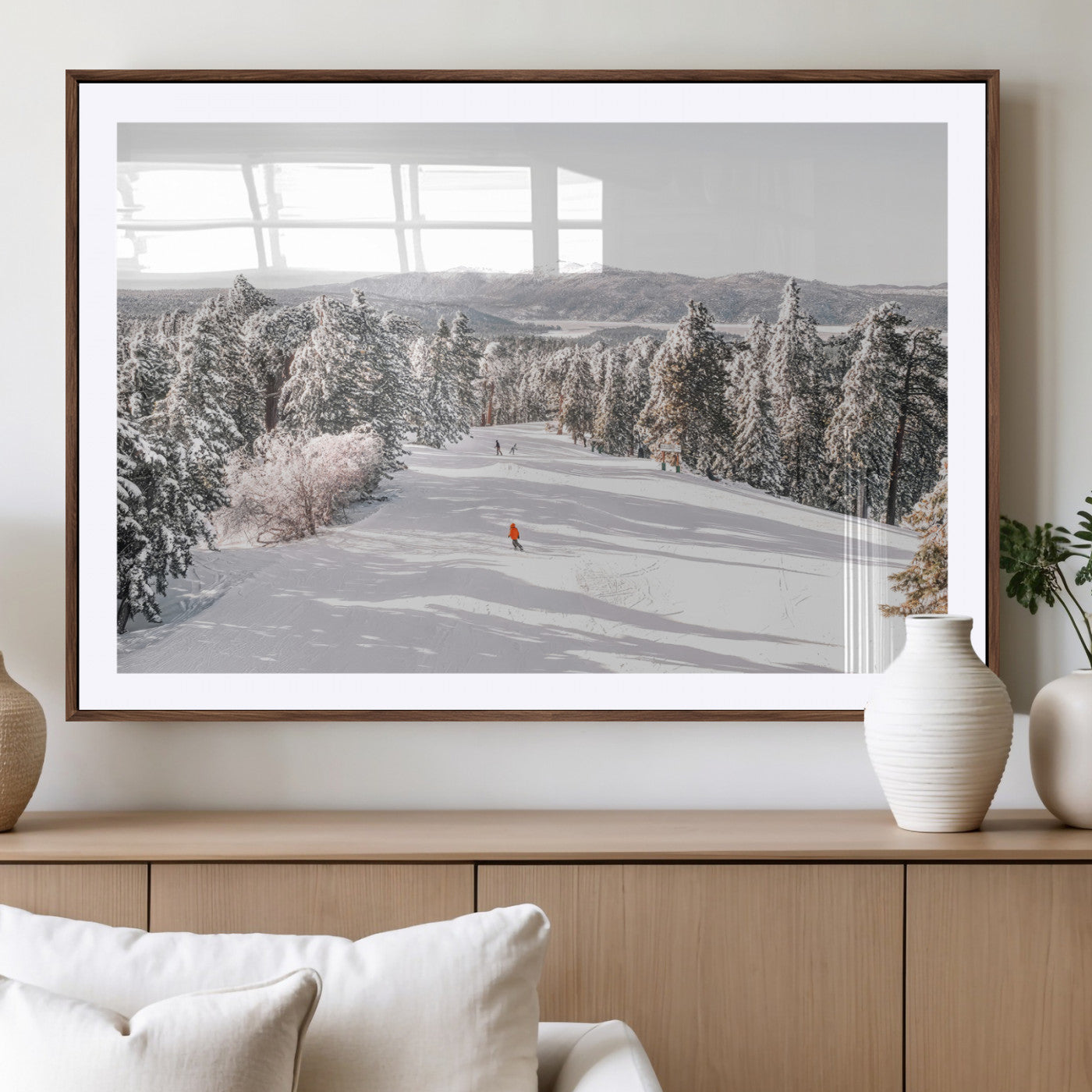 Bright ski trail lined with snow-covered pines and a skier in orange, perfect for alpine adventure or winter sports-inspired decor.