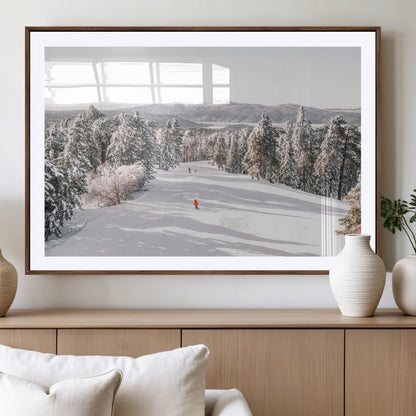 Bright ski trail lined with snow-covered pines and a skier in orange, perfect for alpine adventure or winter sports-inspired decor.