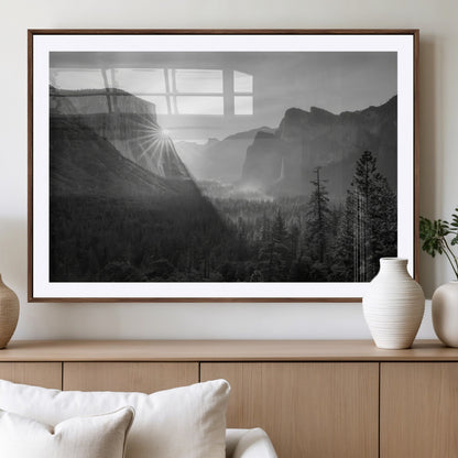 Black and white landscape of Yosemite with sun rays peeking over El Capitan, ideal for moody nature or modern rustic decor.