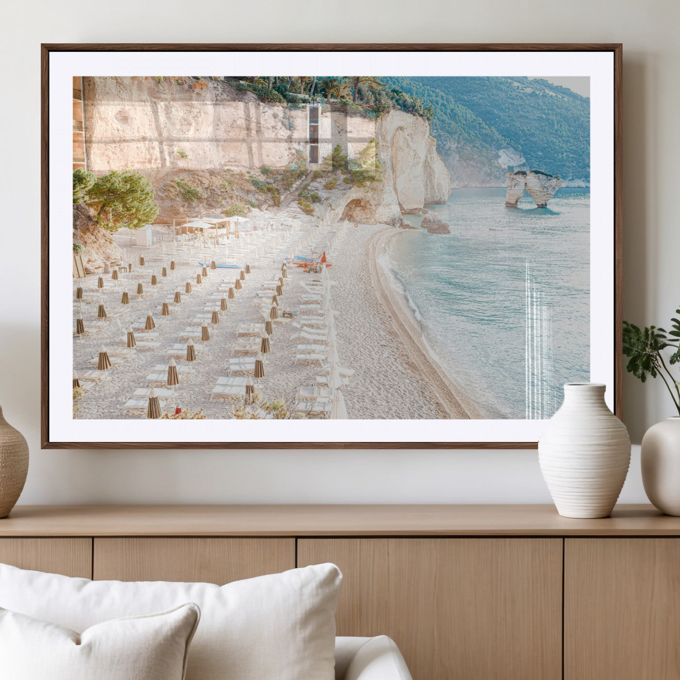 Wall art of a calm Mediterranean beach with rows of sun loungers and umbrellas in soft pastel tones, perfect for light coastal or vacation-themed decor.