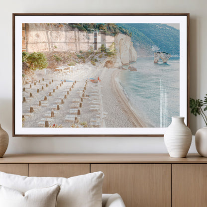 Wall art of a calm Mediterranean beach with rows of sun loungers and umbrellas in soft pastel tones, perfect for light coastal or vacation-themed decor.