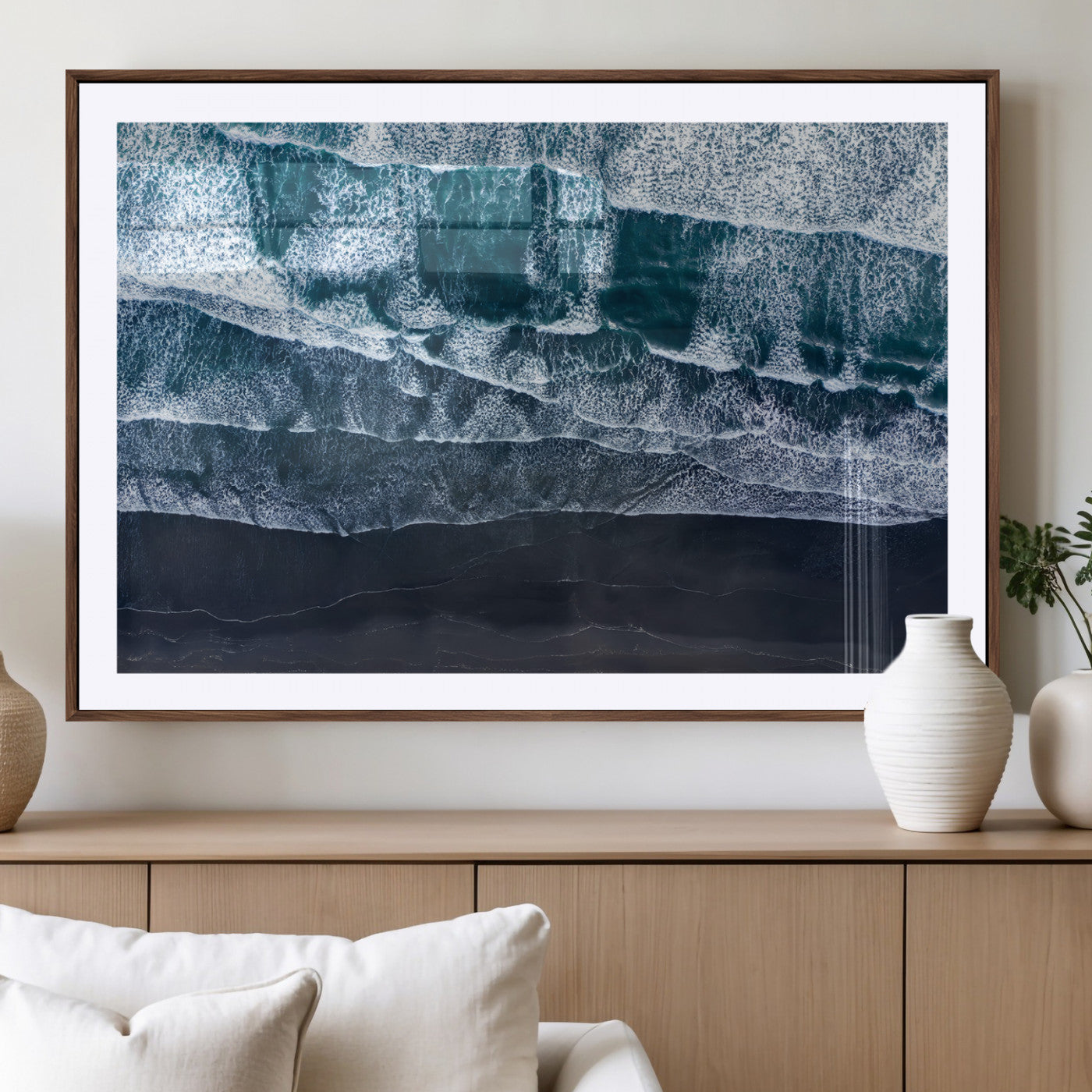 Canvas of aerial ocean waves crashing onto a black sand beach in moody tones, ideal for modern coastal or minimalist home decor.