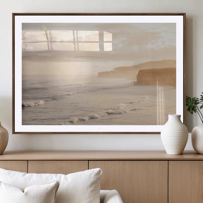 Golden hour seascape with misty cliffs and gentle waves rolling towards the shore, capturing a tranquil and warm coastal atmosphere.