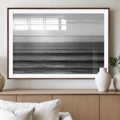 Minimalist black and white ocean view with layered waves reflecting sunlight, evoking a sense of calm and coastal serenity.