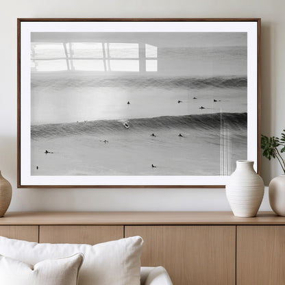 A monochrome photograph of swimmers gliding through gentle ocean waves, evoking a sense of calm and movement.