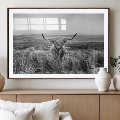 A black and white portrait of a Highland cow in a foggy Scottish countryside, capturing a rustic aesthetic and tranquil farm escape.