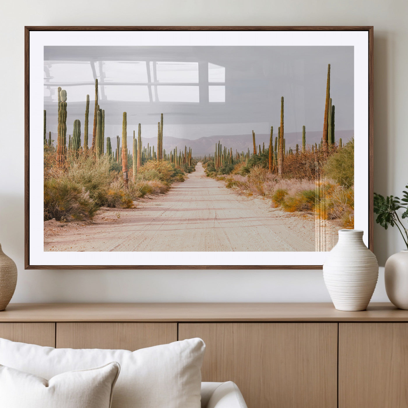 A desert road lined with saguaro cacti under a golden sky, creating a warm southwestern feel, perfect for boho or rustic decor.