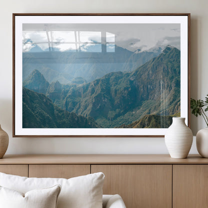 A misty mountain landscape with cloud-covered Andean peaks and lush green valleys, creating a dramatic and serene view, perfect for rustic or nature-inspired home decor.