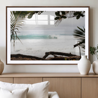 Tropical beach view with palm trees and surfer riding a wave, perfect for boho or coastal-inspired interior wall decor.
