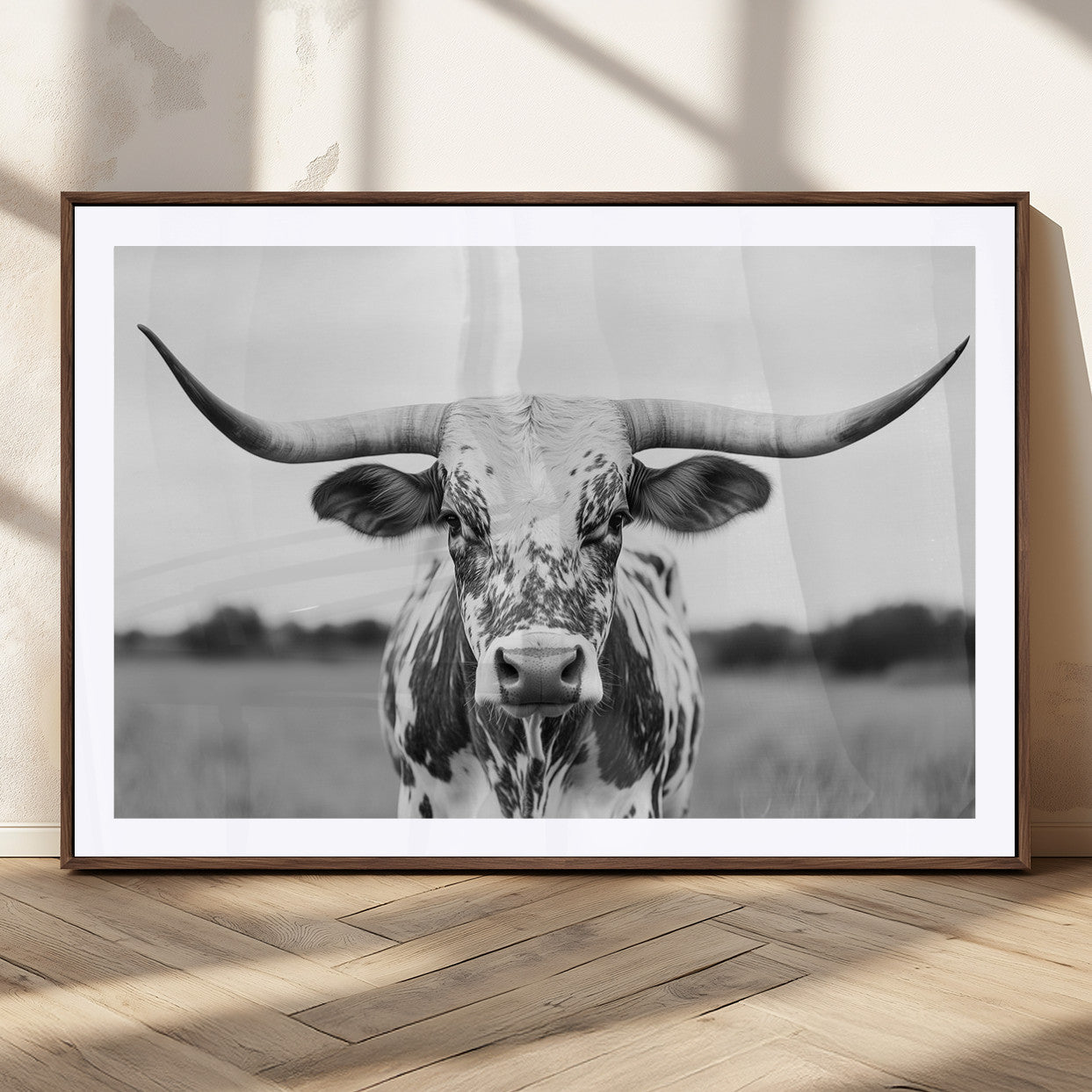 Capture the strength and elegance of nature with this striking black and white portrait of a longhorn cow. Its powerful presence makes a bold statement in any room.