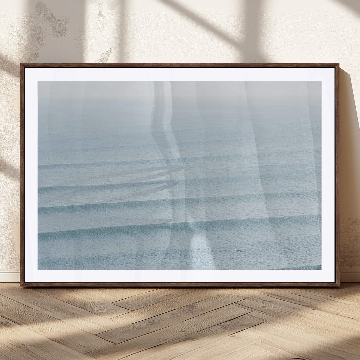 Framed canvas of repeating ocean waves with a distant solo surfer, ideal for minimalist ocean or calm coastal wall decor.