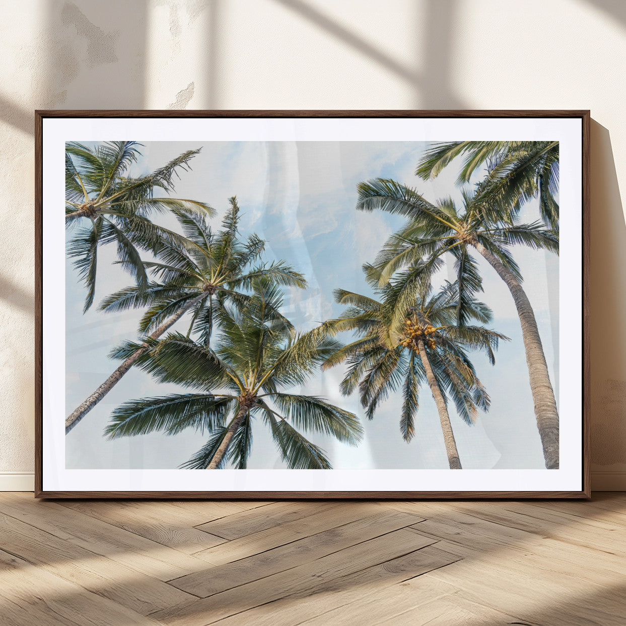 Framed canvas of tall palm trees reaching into a tropical sky, ideal for beach home or relaxed island-inspired wall decor.