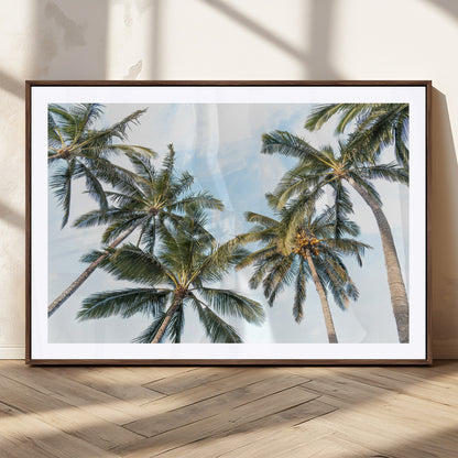 Framed canvas of tall palm trees reaching into a tropical sky, ideal for beach home or relaxed island-inspired wall decor.