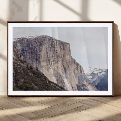 Framed canvas of El Capitan’s vertical granite face in Yosemite with snowy peaks, ideal for Sierra minimalism or mountain-inspired decor.